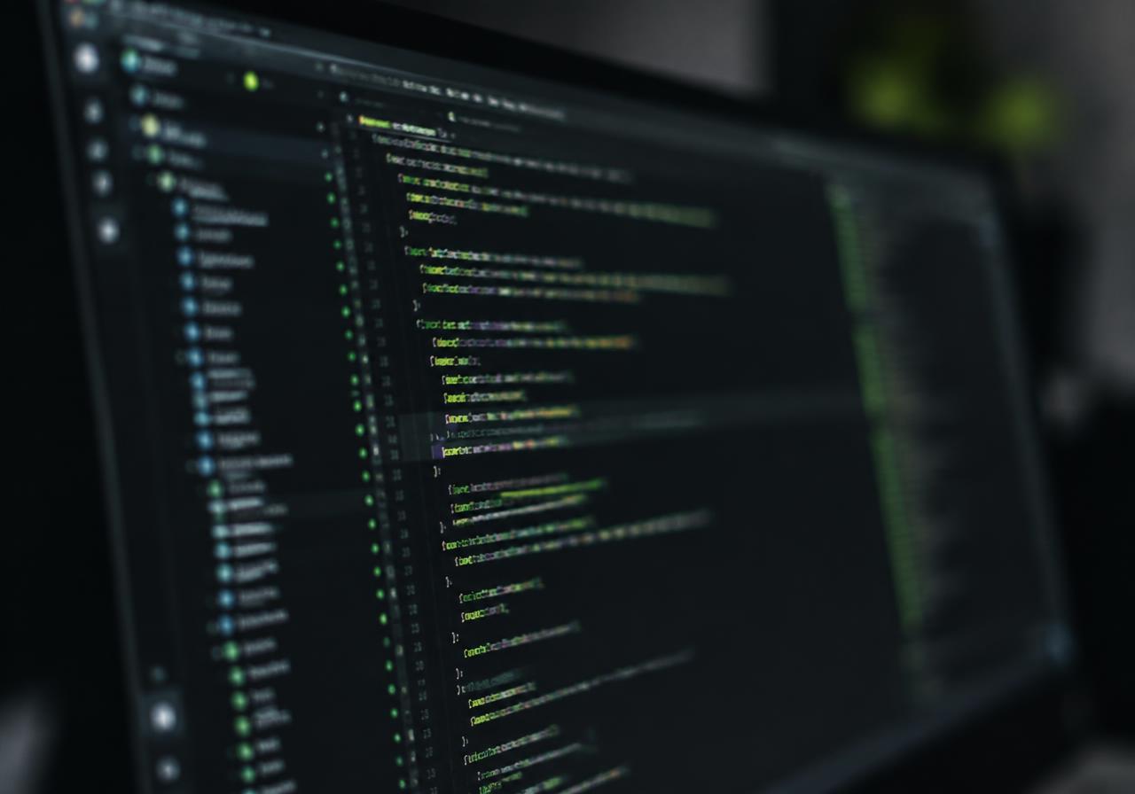 Code editor on a monitor with green syntax highlighting